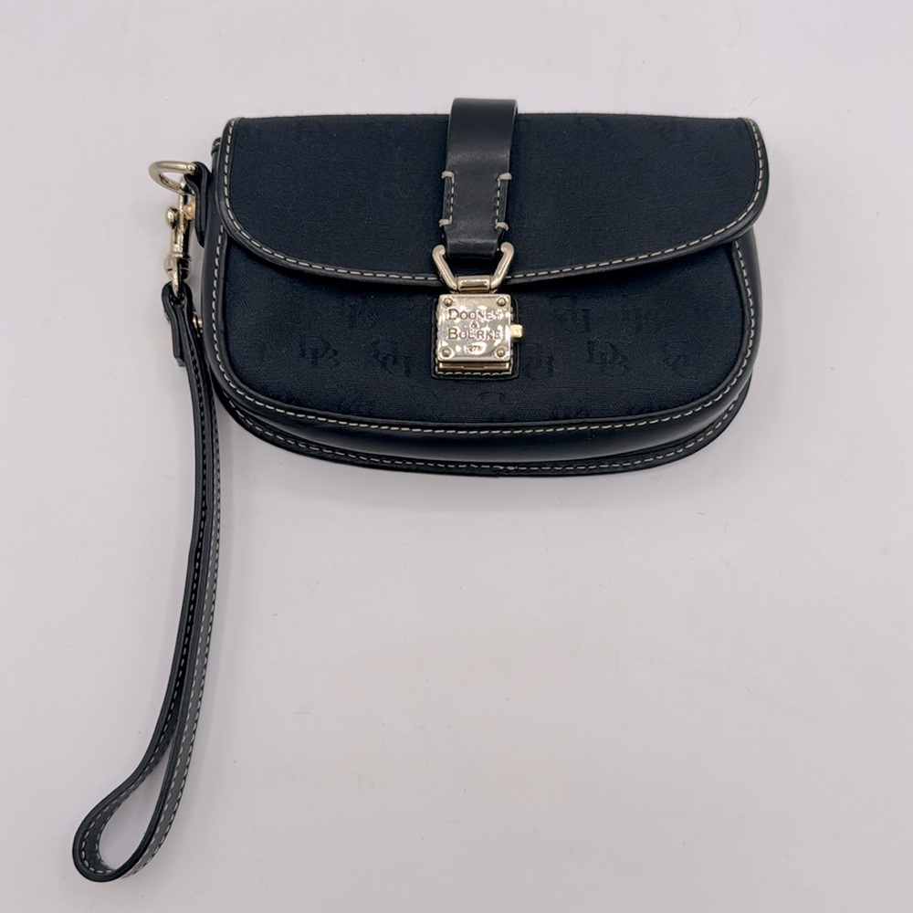 Dooney & Bourke wristlet clutch. Black logo ,gold trim, and buckle closure.